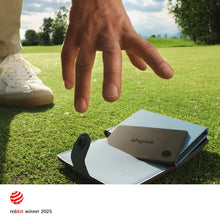 Chipolo CARD tracker card with chipolo logo in a dark wallet holder, outdoors