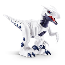 White robotic raptor dinosaur toy with blue spots and red mouth, angled view