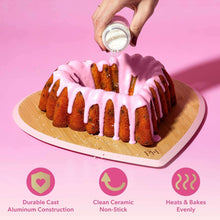 Pink heart-shaped fluted baking pan on a board, ridged sides visible
