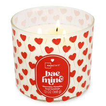 Valentine hearts 3-wick candle in clear jar, lit wicks, red heart label.