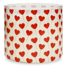 Valentine hearts 3-wick candle jar with repeating red heart print around the glass.