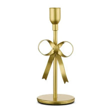 Gold metal taper candle holder with ribbon bow and round base