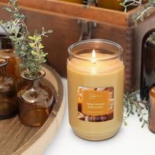 Lit salted caramel butterscotch candle in glass jar, single wick