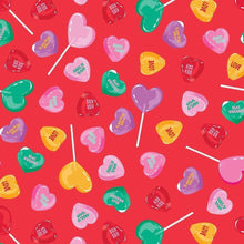 Heart-shaped candy pattern on red paper bag surface with colorful heart pops