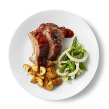 White round dinner plate with food serving, glossy smooth surface