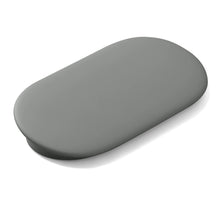 Streaming media streamer, oval gray set-top box with smooth top surface.