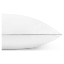 White pillow edge close-up with soft fabric and blue corner tag