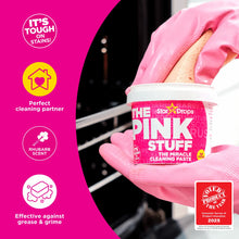 Pink Stuff cleaning paste tub held in pink rubber gloves