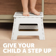 White folding step stool with slatted top and rectangular side cutouts