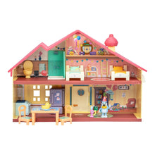 Toy playset house close-up showing kitchen area, furniture, and figurines