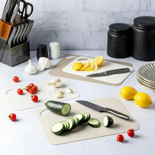 Cream poly cutting mats with side handle cutouts, laid out in a set