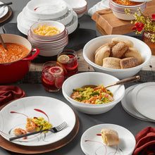 White glass dinnerware set with red and gray swirl pattern, plates and bowls