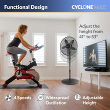 Black oscillating pedestal fan with tall pole and round base, front grille facing forward