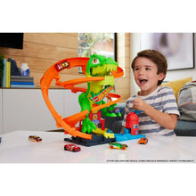 Dinosaur T-Rex track playset with orange rails, green T-rex figure, and toy cars