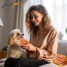 Dog treat chews on a plate while a woman feeds a dog