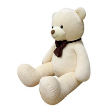 Cream corduroy plush bear shown seated from a three-quarter angle