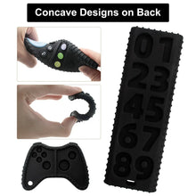 Black silicone teething toys with textured concave backs on controller and remote.