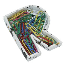 White speckled clay tray holding colorful paperclips and binder clips