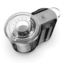 Mini food chopper showing clear bowl and stainless blade hub on black motor base