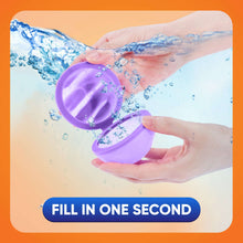Purple reusable water balloon being filled underwater between hands