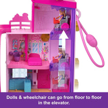 Pink dollhouse compact with open elevator side and micro dolls inside