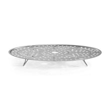 Silver perforated steaming rack with round surface and three support legs