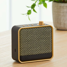 onn small Wi-Fi speaker, black and gold mesh body with top control buttons