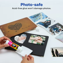 Hands using a white glue stick on a photo collage craft card