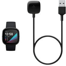 Smartwatch charging cable with USB-A end and charging puck, shown with smartwatch.