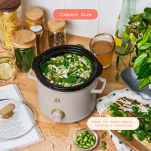 Porcini taupe manual slow cooker with black lid, filled with vegetables