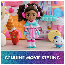 Winter dress-up doll standing in confection-themed playset, pastel outfit and boots