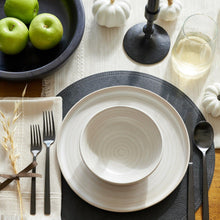 Black stainless steel fork and spoon near a white plate