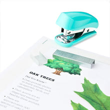 Blue mini stapler pressing staples into papers, chrome nose and clear base