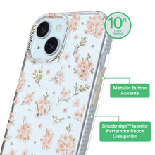 Clear phone case with pink floral print and metallic button accents
