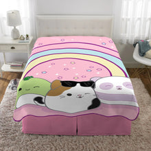 Plush blanket on bed with pink rainbow stripes and three animal faces print