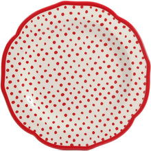 Dinner plate with cream surface and scattered red polka dots, outlined in red