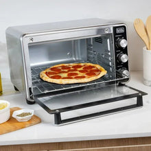 Air fryer toaster oven with pizza inside on wire rack, door open