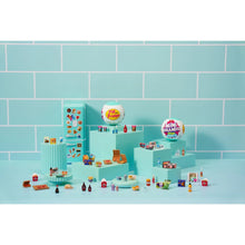 Mini fridge playset with shelves and scattered miniature food and drink items