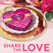 Opened heart-shaped chocolate box with Ghirardelli candy pieces and wraps