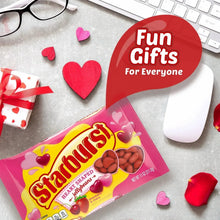 Heart-shaped jelly beans candy bag on a gray surface with red hearts and a gift