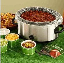 Slow cooker liner in a silver slow cooker with red food and crimped foil rim
