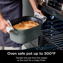 Green multi-cooker with pot on oven rack, lid removed and food inside