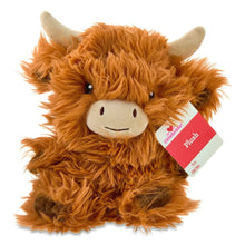 Brown plush Highland cow with dangling fabric tag and shaggy fur, smiling face