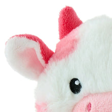 Close-up pink and white cow plush face with black eye and pink nose