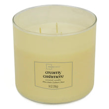 Creamy cashmere scented candle in cream wax with two lit wicks and front label