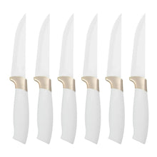 Row of stainless knives with white handles and gold-toned bolster accents