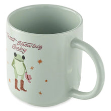 Light green ceramic mug with baby frog in boots and “That’s Showbiz Baby” text