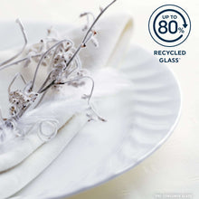 White coupe glass dinner plate with visible glass chip near edge