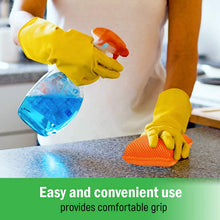 Orange microfiber sponge with yellow gloves, scrubbing a kitchen countertop