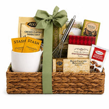 Woven comfort gift basket filled with soup, tea, biscuits, snacks, a mug and whisk